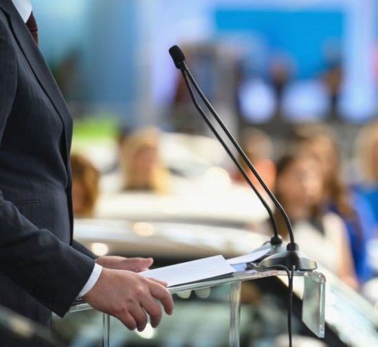 Politician speaking publicly from the lectern during political rally, Nikon Z7