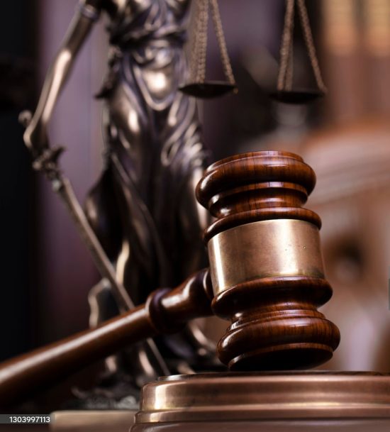Judge?s gavel, Themis sculpture and collection of legal books on the brown background.